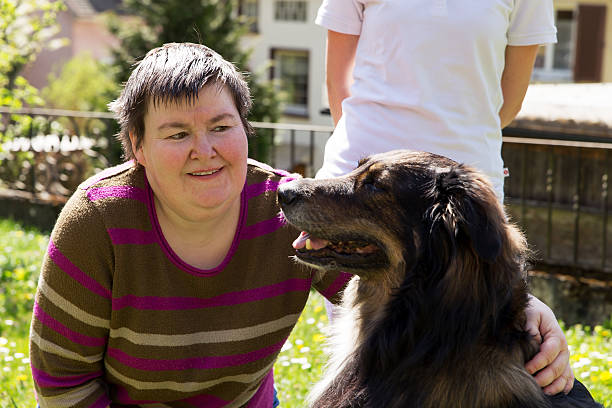 istock disabled woman is caress a dog 470618412