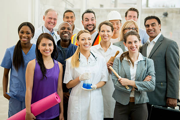 Group of Varied Professionals A multi-ethnic group of mixed professionals standing together in their work attire. various occupations stock pictures, royalty-free photos & images