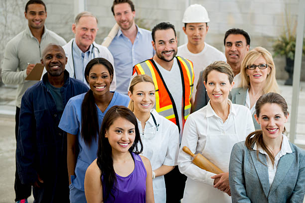 Group of Multi-Professionals A multi-ethnic group of mixed professionals standing together in their work attire. various occupations stock pictures, royalty-free photos & images