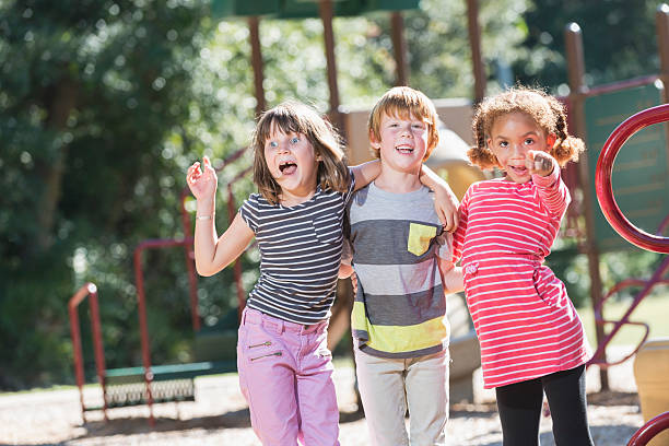 istock Three playful multiracial children on playground 470621068