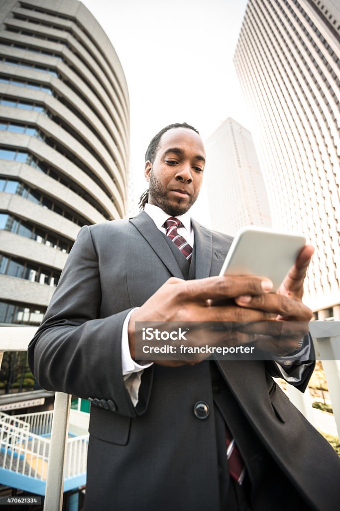 Afro Business man using the smartphone on Tokyo Business man using the smartphone 2015 Stock Photo