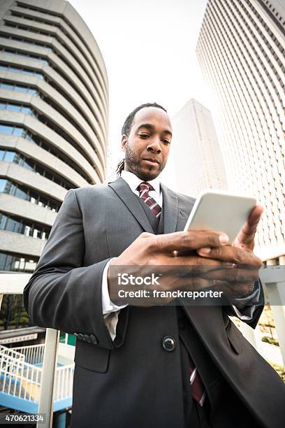 Afro Business Man Using The Smartphone On Tokyo Stock Photo - Download Image Now - 2015, 30-39 Years, Adult