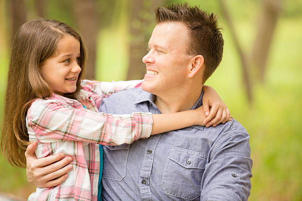 istock Father, daughter hugging outdoors. Parent, child. Love, affection. 470621362