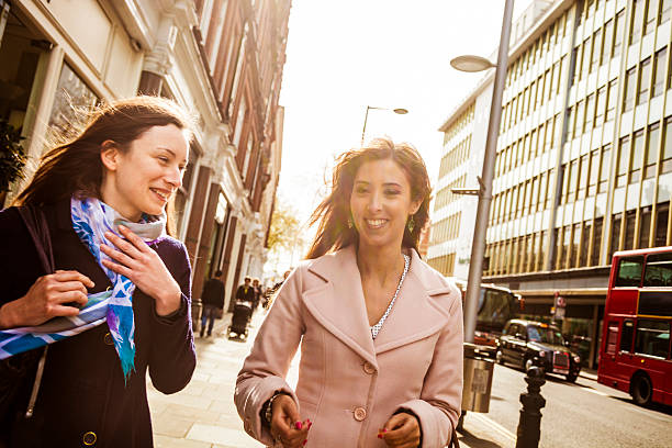 istock Two happy friends walking in the city 470621416