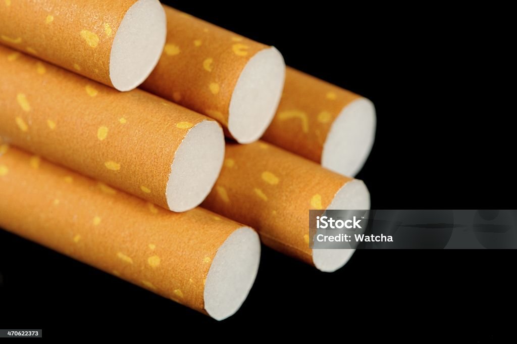 Os cigarros com filtros de cor amarela sobre fundo preto - Royalty-free Cigarro Foto de stock