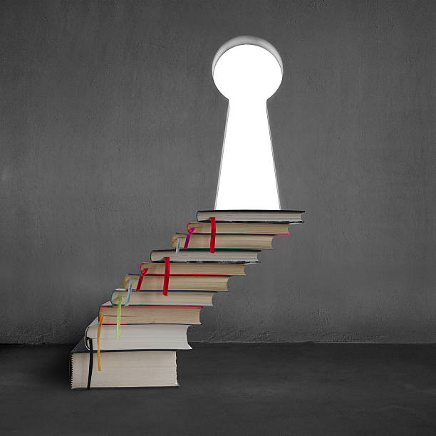 istock Stack of books with key shape door on concrete wall 470624859