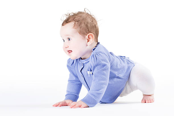 istock Little baby girl learning to crawl 470625225