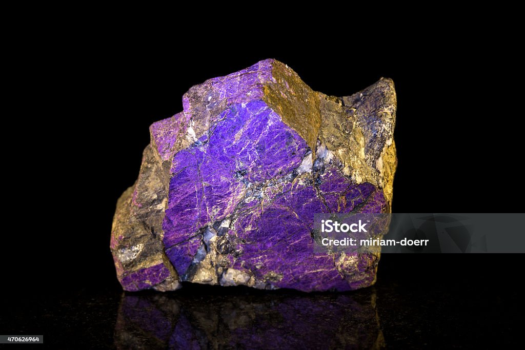 purpurite mineral stone in front of black purpurite mineral stone, black background 2015 Stock Photo