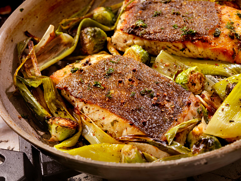 Crispy Skin Grilled White Fish Roasted with Leeks and Brussels Sprouts on a gas stove - Photographed on Hasselblad H3D2-39mb Camera