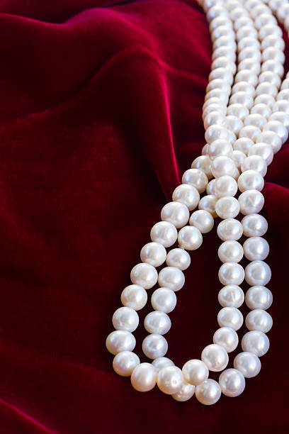 istock red velvet background with pearls 470627834