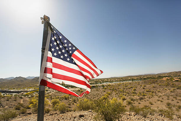 istock Torn American Flag Waving in The Desert Wind 470628850