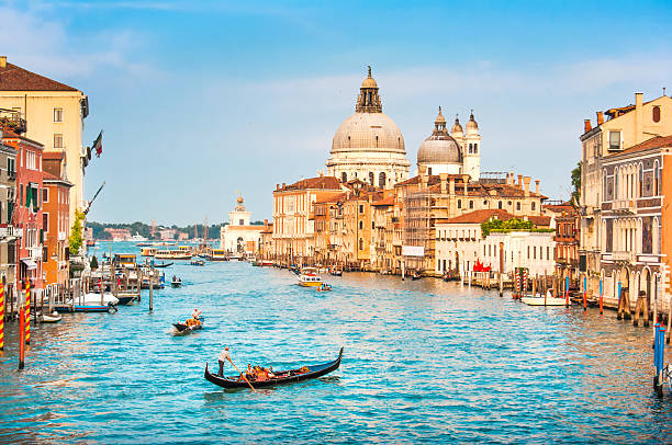 Gondola on Canal Grande at sunset, Venice, Italy Beautiful view of Gondola on famous Canal Grande with Basilica di Santa Maria della Salute at sunset in Venice, Italy. grand canal venice stock pictures, royalty-free photos & images