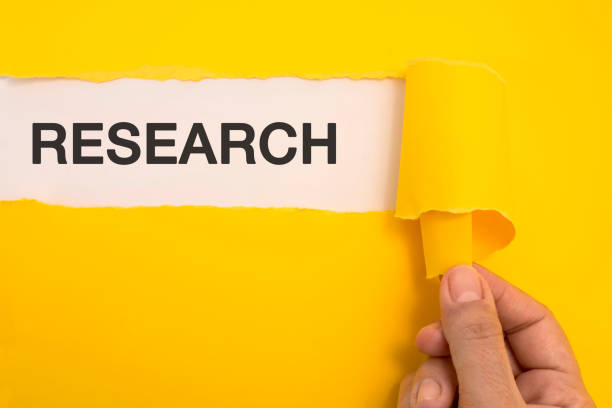 istock Female hand tearing the word Research 470630100
