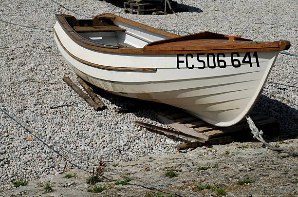 A yellow Lunenburg dory tied up at a dock in Lunenburg Harbor, Nova Scotia.