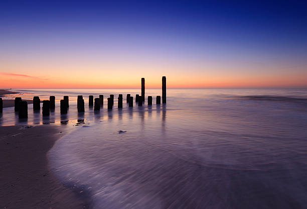 Magical sunrise at Horsey Beach in Norfolk. Rusting Defenses stand valiantly as the salt water corrodes while caressing their metallic surface.