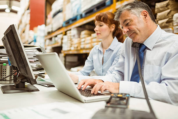 istock Manager working with laptop and talking on phone 470632696