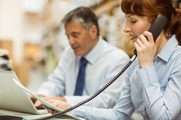 istock Manager working with laptop and talking on phone 470633038