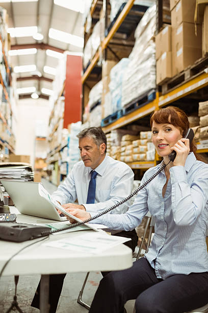 istock Manager working with laptop and talking on phone 470633094