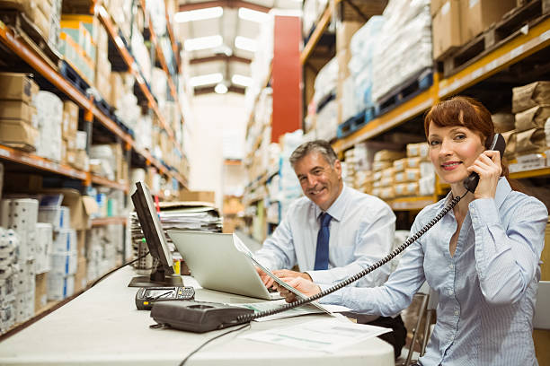 istock Manager working with laptop and talking on phone 470633110
