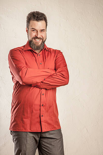 istock Confident man in red shirt with arms crossed 470635010