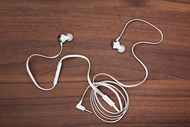 istock White earphones and cable on wood 470635410