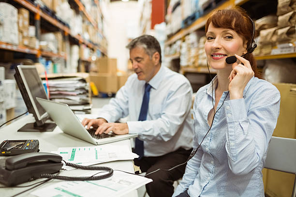 istock Warehouse manager working at her desk wearing headset 470635508