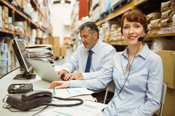 istock Warehouse manager working at her desk wearing headset 470635510