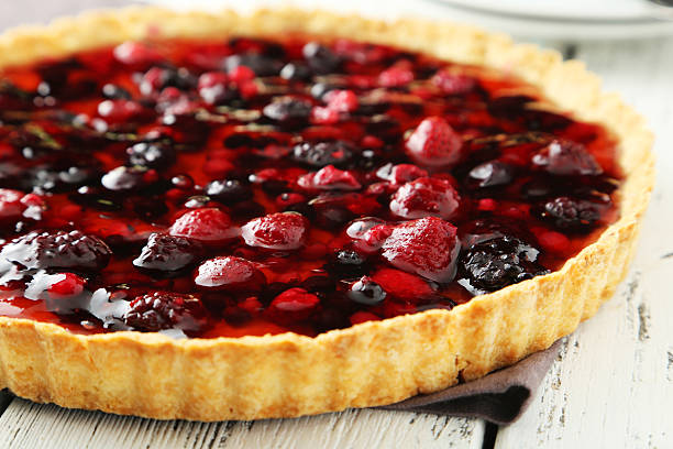 istock Fresh berry tart on white wooden background 470639664