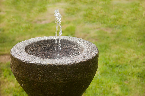 istock Stone drinking fountain in a garden. 470639742