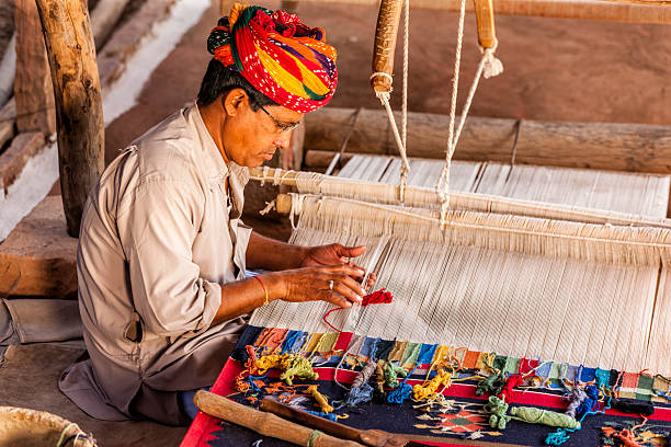 istock Indian man weaving textiles (durry) in Rajasthan 470639824