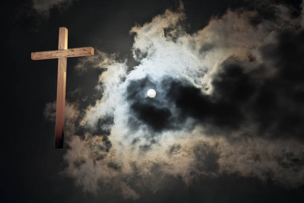 istock Cross with a dark sun and sky- copy space 470640598