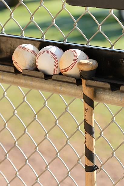 istock Baseballs and bat hanging in dougout 470640600