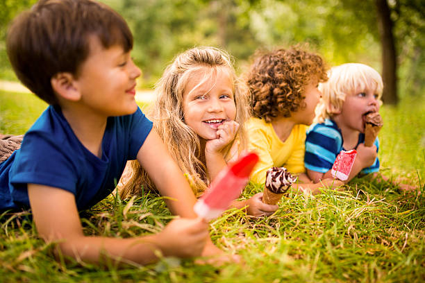 istock Friendly kids happily enjoying ice creams in the park 470643144