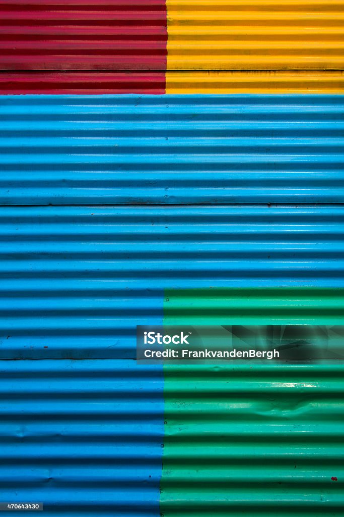 Colorful and full frame background image of a corrugated wall Colorful and full frame background image of a corrugated wall in La Boca district, Buenos Aires. The wall is painted in blue, yellow, red and green. Caminito Stock Photo