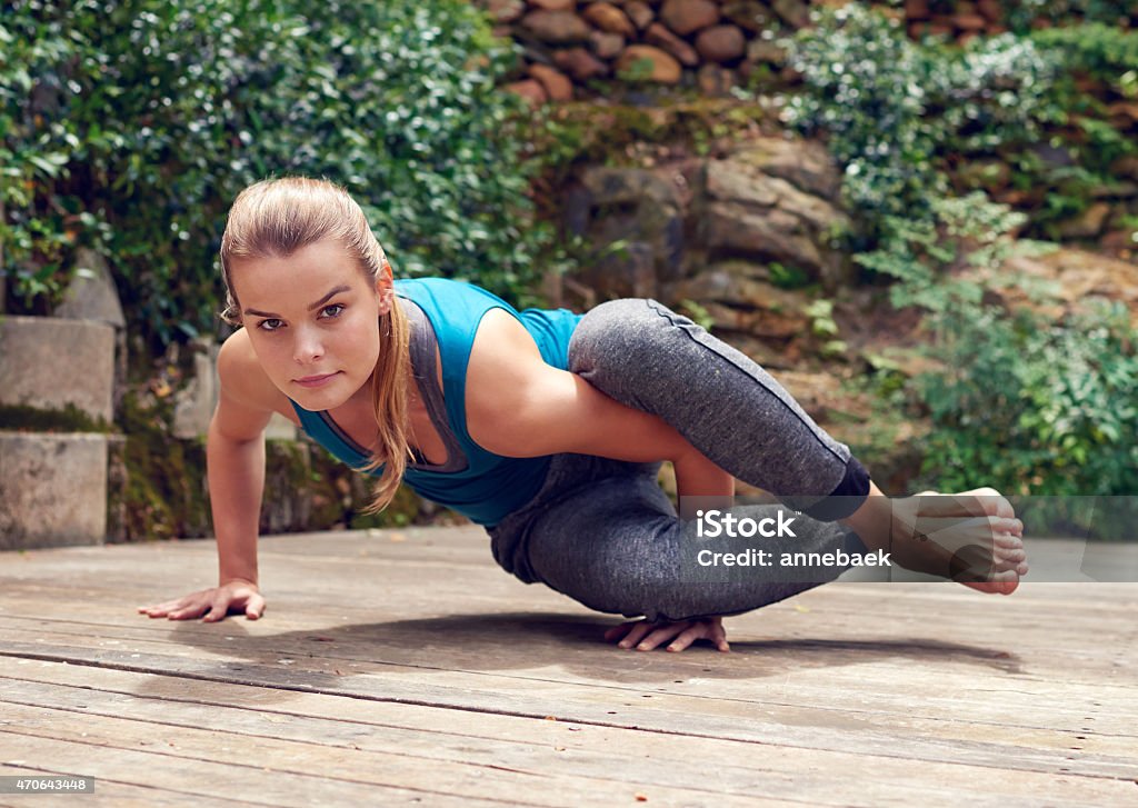 Owning the eight angle pose Shot of a young woman practicing yoga outdoorshttp://195.154.178.81/DATA/i_collage/pu/shoots/796805.jpg 2015 Stock Photo