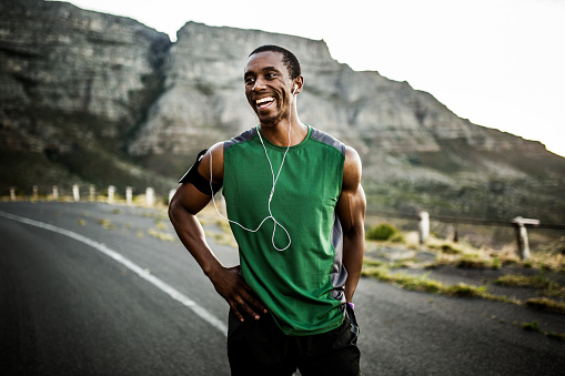 African athlete smiling positively after a good training session outdoors
