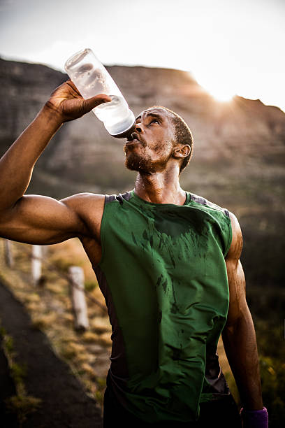 istock Athlete drinking thirstily from a water bottle outdoors 470643962