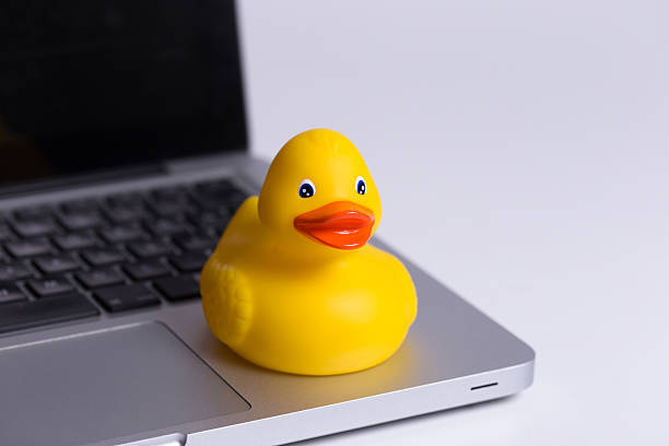 istock Yellow Duck Toy on Laptop 470644300