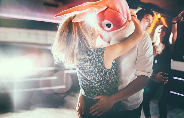 istock Romantic couple, with guy in a bunny head dancing together 470644574