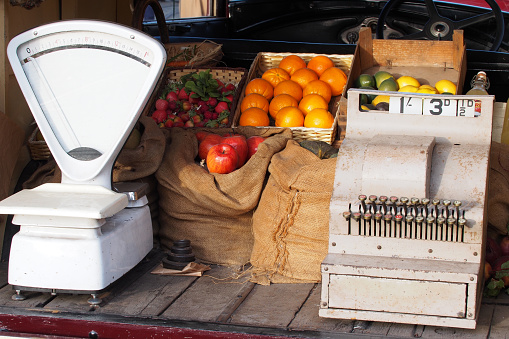 Recreation of a fruit seller van from pre-war England, with weighing scales in pounds and ounces and a cash register in old money (pounds, shilling and pence)