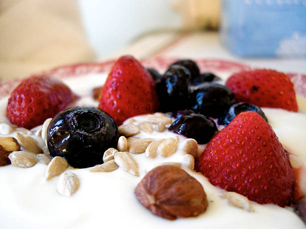 Healthy breakfast,berries and nuts in a bowl of yogurt. stock photo