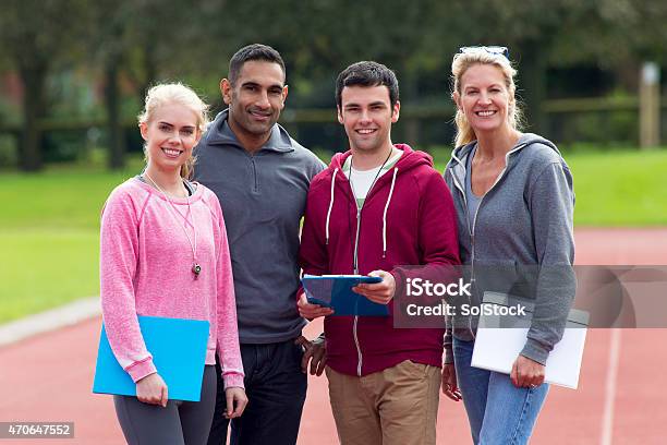 Four Happy Gym Coaches Stock Photo - Download Image Now - Physical Education, Teacher, Multiracial Group