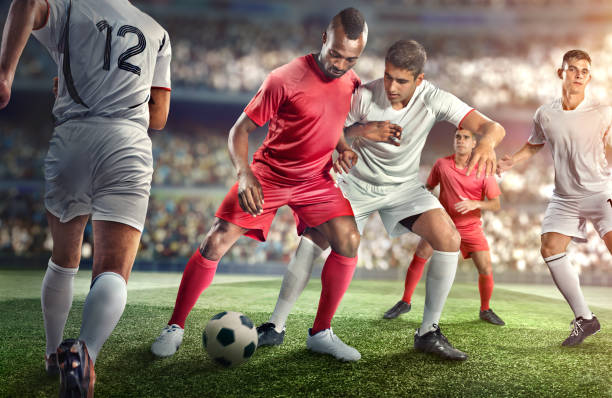 Soccer player kicking ball in stadium