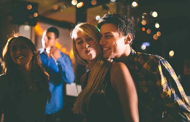 istock Happy loving couple out having fun dancing making kissy face 470648572