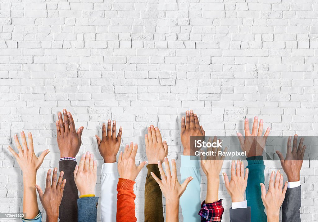 Group Of Multi-Ethnic People's Arms Outstretched In A White Back Group of multi-ethnic people's arms outstretched in a white background. 2015 Stock Photo