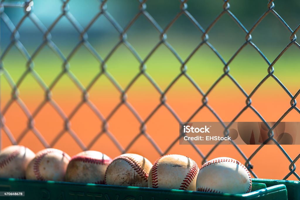Baseballs in dugout Various baseballs lined up for use in baseball dugout  Baseball - Ball Stock Photo