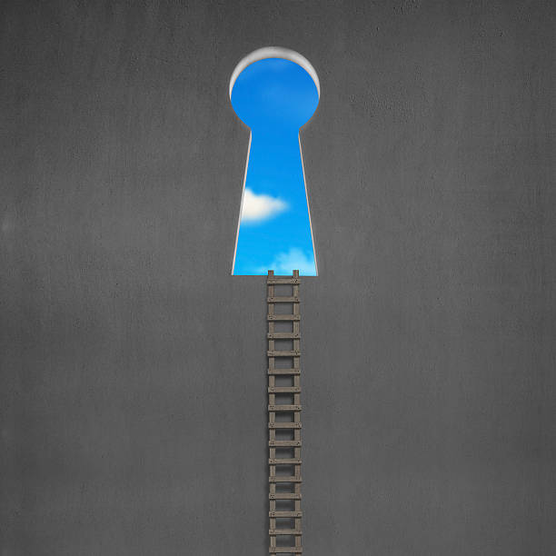 istock Ladder with key shape door on wall and blue sky 470650241