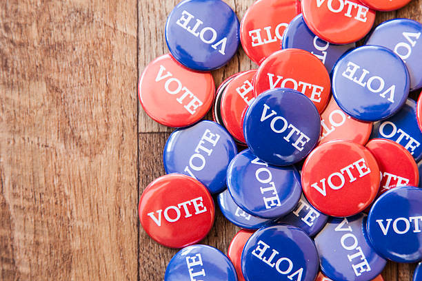 istock Red and blue voting badges on a wooden background 470654240