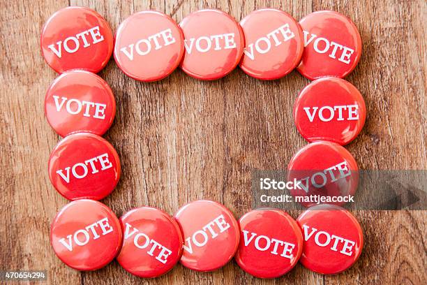 Collection Of Red Voting Badges On A Wooden Background Stock Photo - Download Image Now