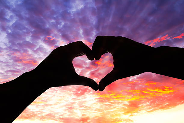 istock Silhouette hand in heart shape and beautiful sky 470654730
